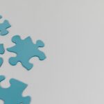 Close-up of blue puzzle pieces on a white background with copy space.